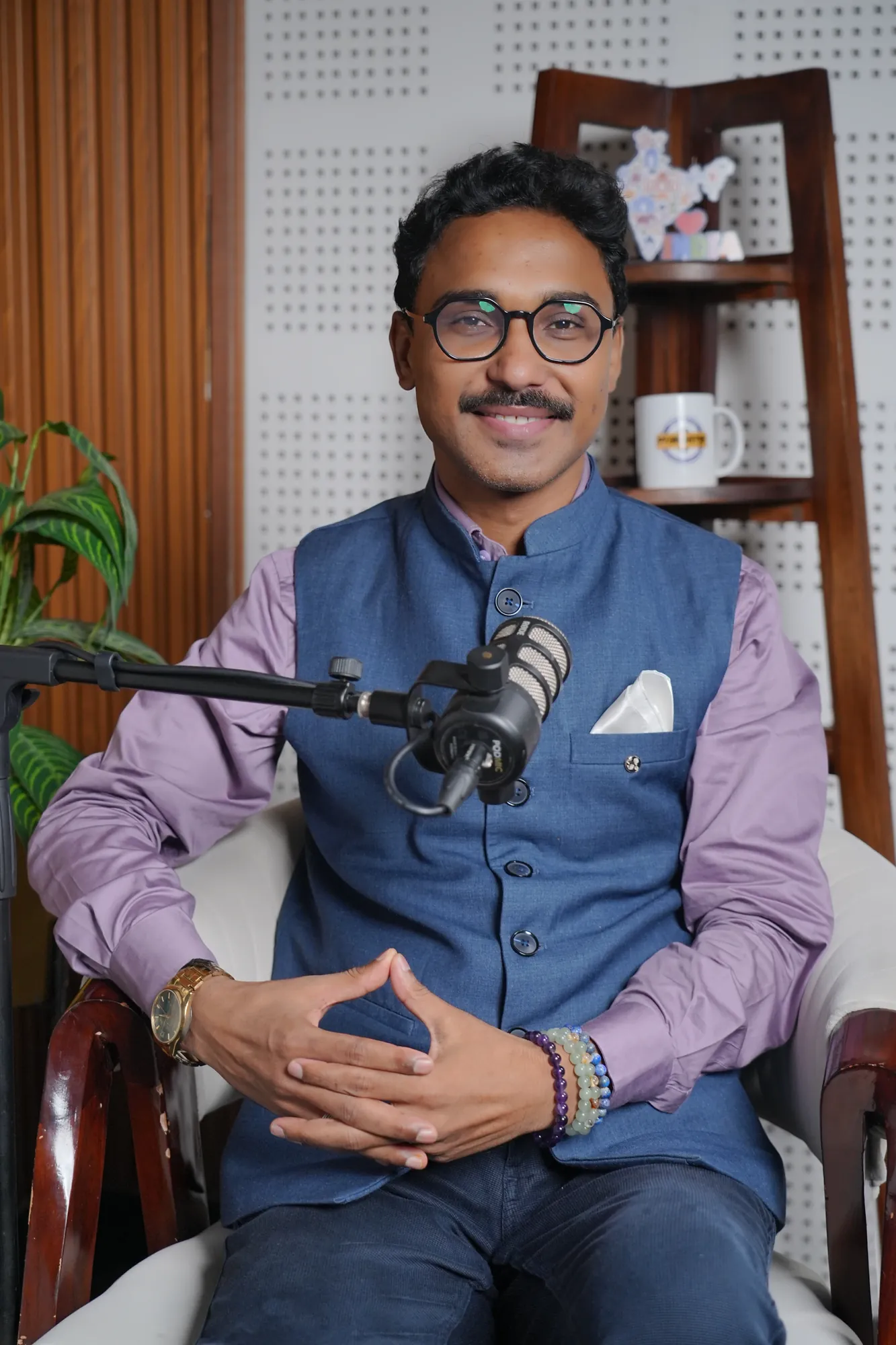 Adarshh Panndey seated at a podcast microphone